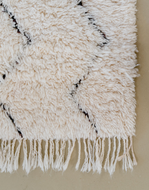 Zoom sur les franges de ce tapis